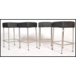 A set of 4 contemporary retro chrome and faux leather bar stools. Each on tubular bases with