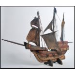 A vintage 20th century wooden model of a Spanish Galleon ship. Measures 53cms high.