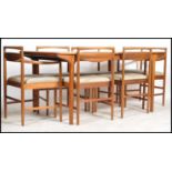 A 1970's McIntosh large rectangular teak wood dining table and chairs. The extending teak dining