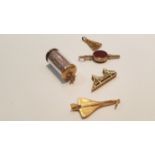 A collection of 9ct gold charms to include Concorde, ladies fan,. bank roll, bloodstone seal fob and