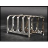 A silver hallmarked Mappin and Webb four section toast rack having twin Art Deco shaped stepped