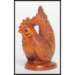 A Chinese carved wooden netsuke in the form of a cockerel being signed to the underside. Measures