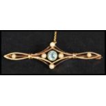 An early 20th century 15ct gold, seed pearl and aquamarine coloured stone brooch of bar form ,