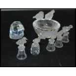 A group of Swarovski bird figurines to include a frosted and cut faceted glass bird bath figurine