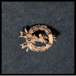 A 9ct gold Ancient Order of Foresters brooch depicting a stag with wreath decoration Weighs 1.4