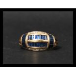 A 14ct gold blue sapphire and diamond ring having baguette cut blue sapphires and round cut diamonds