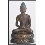 A 19th century Chinese bronze figurine of a Buddha modelled in the lotus position holding a pot