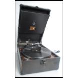 A vintage 20th century portable picnic HMV gramophone with record compartment to the hinged lid