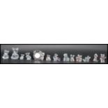 A group of thirteen Swarovski figurines of bears to include koala, clock, artist, heart bears etc.