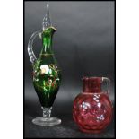 A 19th century cranberry glass jug handpainted ove
