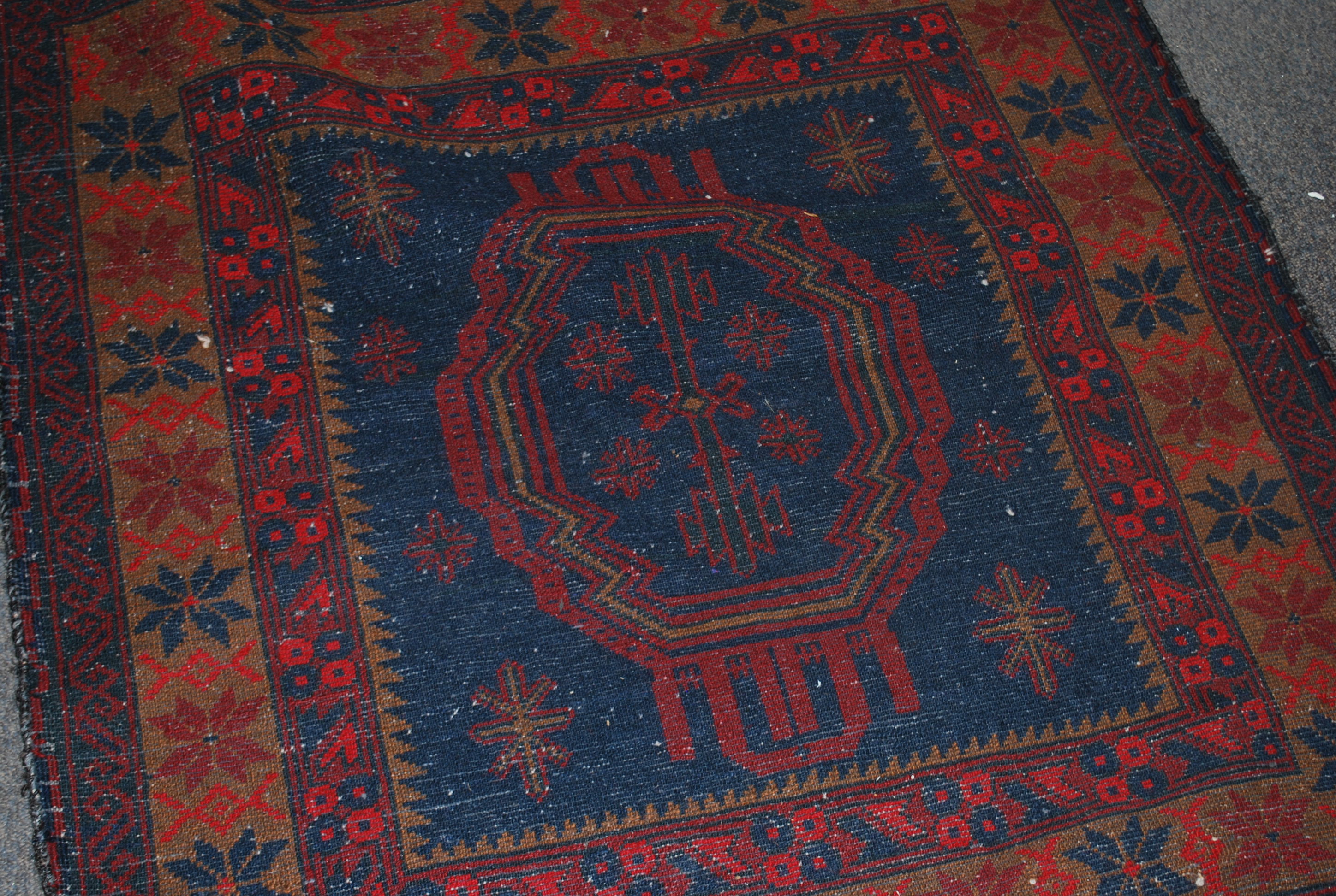 A Persian Islamic floor rug having a deep red and - Image 2 of 4