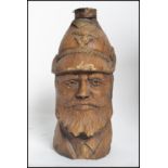 An unusual carved / pulp wood beer bottle in  the