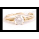 A hallmarked 14ct gold and CZ solitaire ring being set with a single round cut CZ. Hallmarked