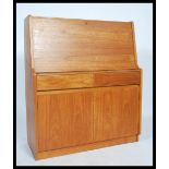 A retro 20th century Danish influence teak wood bureau desk having a fall front with fully appointed
