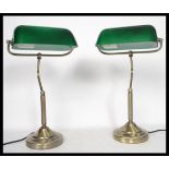 A pair of vintage 20th century bankers desk lamps having green glass shades with adjustable goose
