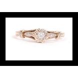 A hallmarked 9ct gold and diamond ring set with a single central diamond and diamond accent