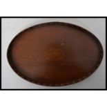 A 19th century Victorian small mahogany tray having an inlaid shell cartouche with raised