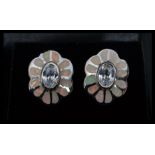 A pair of silver and enamel set stud earrings in the form of flowers having central white stones.