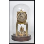 Gustav Becker - A perpetual brass anniversary clock having a glass dome and a wooden socle plinth