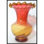 A large mid 20th century studio art glass vase of bulbous form having a fading cranberry to orange