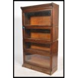 An early 20th century stacking Lawyers oak bookcase cabinet having four glass fronted stacking
