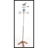 An early 20th century cast metal weather vane having a horse to top raised on a cast metal quadruped