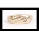 A hallmarked 9ct gold and diamond signet ring set with a single accent diamond. Marked 9ct SE, tests
