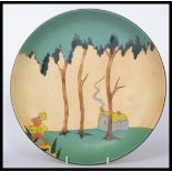 A vintage 20th century Art Deco hand decorated wall charger plate / dish in the manner of Clarice