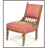 A Victorian mahogany nursing chair raised on turne