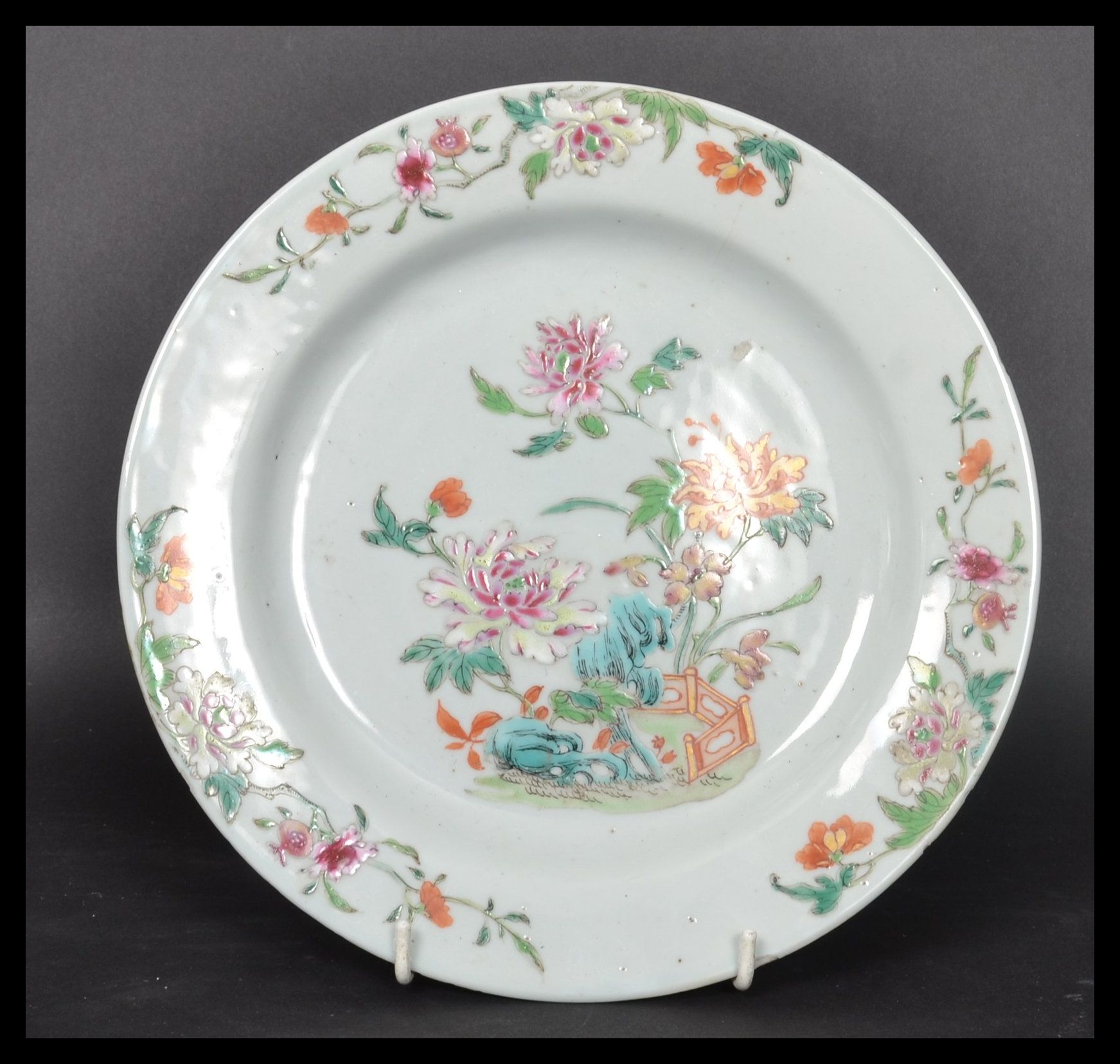 An 18th century Chinese Qing Long Famille Rose plate hand painted with enamels depicting floral