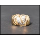 A hallmarked 18ct gold and white stone Italian designer dress ring. The ring decorated with a