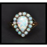 A 9ct gold pear shaped opal cluster ring the central stone having a halo of opals. Weighs 3.3