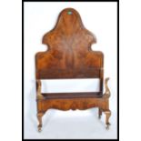 A 1920's walnut Queen Anne revival single bed having oversized walnut headboard with shaped form