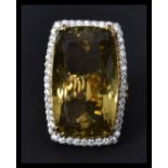 A fantastic and substantial 18ct gold lemon citrine ring having a large central stone of over 50
