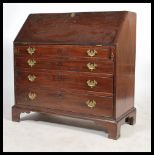 A 19th century Georgian mahogany bureau having a drop front opening to reveal a writing desk area