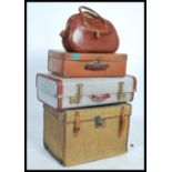 A collection of travel trunks / suitcases dating from the early 20th century to include a steamer