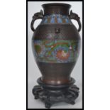 A 19th century Chinese archaistic bronze vase of baluster form. With twin handles modelled as