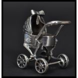 A sterling silver miniature model of a pram / perambulator. Weighs 21.3 grams.