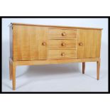 An original Gordon Russell walnut sideboard / dresser. Raised on squared legs with a chest to centre