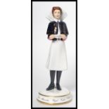 A Michael Sutty ceramic figurine of a nurse limited edition 61/250 model number 2335. Measures 20 cm