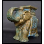 A Chinese 20th century ceramic plant stand in the form of an elephant having a green, blue and white