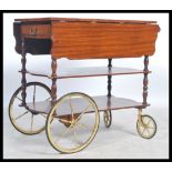 A retro 20th century laquered mahogany buffet serving trolley with large wheels and handle top one