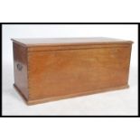 An early 20th century mahogany blanket box of rectangular form with hinged top having brass plaque