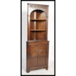 A Jacobean revival Jaycee / Old Charm style oak corner cabinet having an open window shelving unit