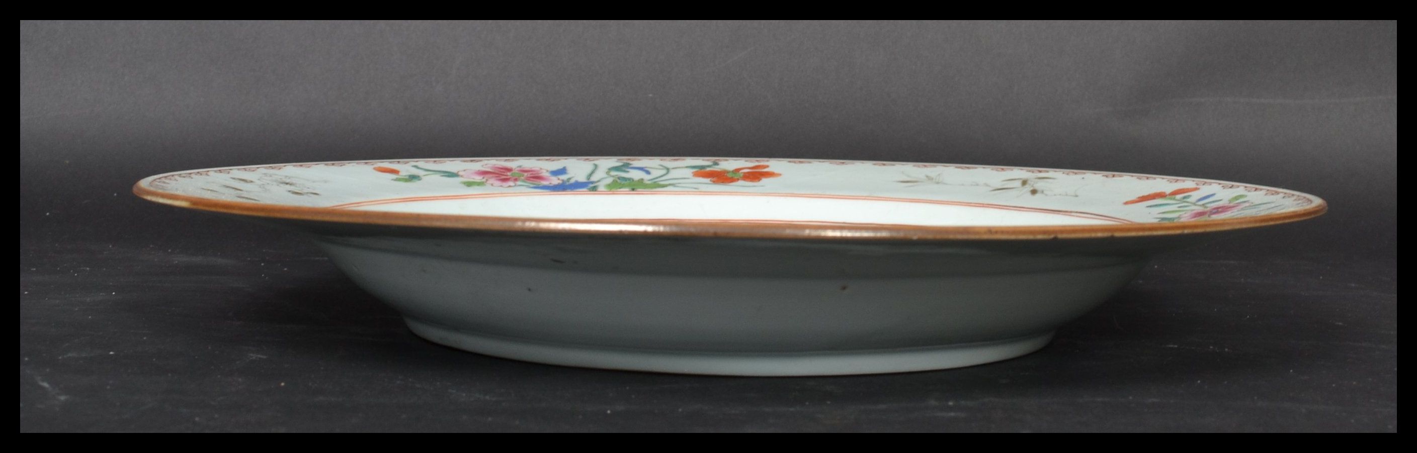 An 18th century Chinese Qing Long Famille Rose plate hand painted with enamels depicting floral - Image 7 of 8