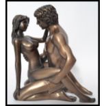 A 20th century bronze effect statuette by Kandy - depicting an erotic scene between lovers. Signed