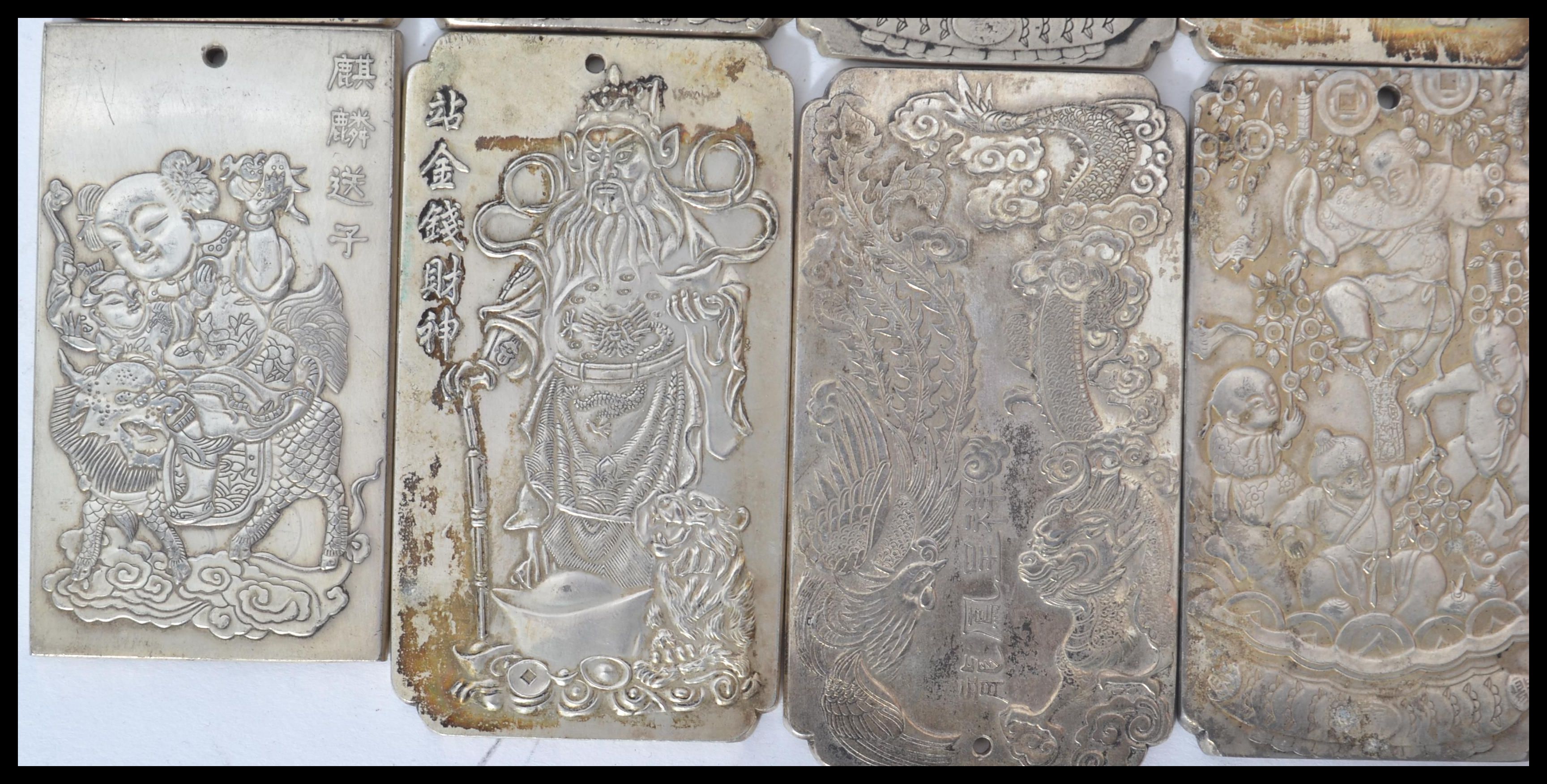 A collection of eight Chinese white metal amulet / scroll weights, cast in relief with various - Image 2 of 5