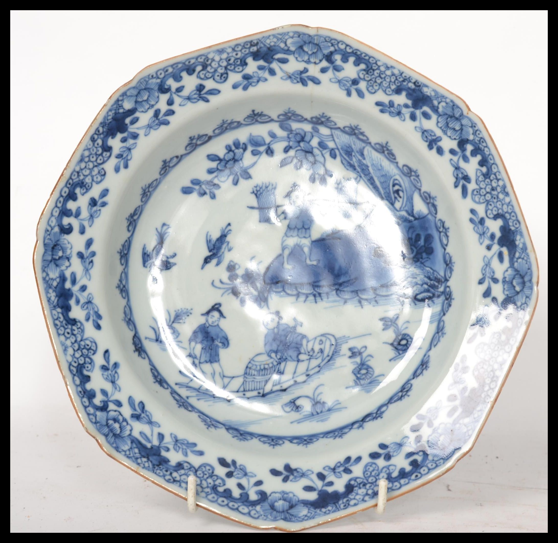 An 18th century Chinese porcelain blue and white plate, the plate decorated with domestic and