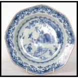 An 18th century Chinese porcelain blue and white plate, the plate decorated with domestic and