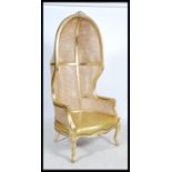 A contemporary gilt wood and bergere Louis 16th revival butlers hooded hall chair. Raised on